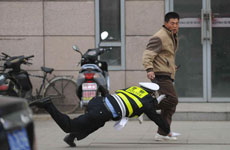  Sinkholes on Shenyang Police Officer Nose Dives To Catch Illegal